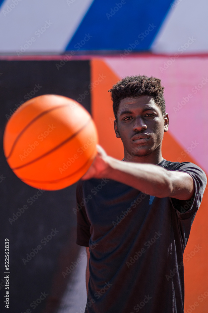 Young man with afro hair style playing with the basketball Young man with afro hair style playing with the basketball
