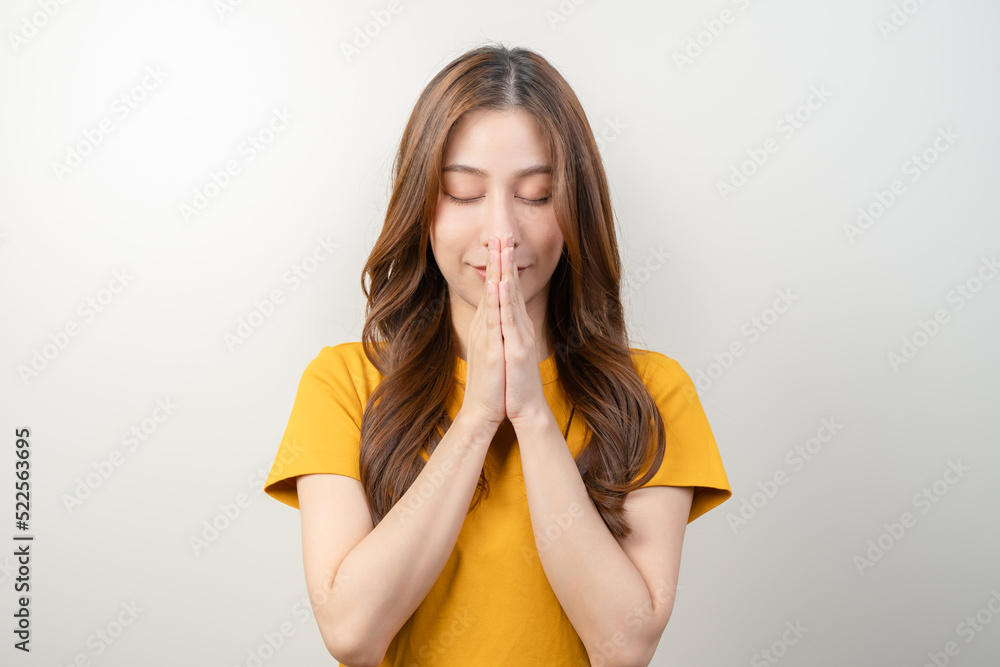 Young woman praying to holy god isolated on background - obrazy, fototapety, plakaty 