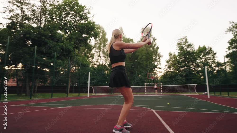 tennis workout on outdoor court, female athlet is running and hitting ball by racket tennis workout on outdoor court, female athlet is running and hitting ball by racket