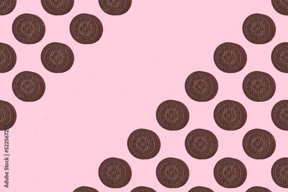 Pattern of chocolate cookies. chocolate Cookies on a pink background. Flat lay. Sweet cookies flat lay pattern on light pink background. Top view...