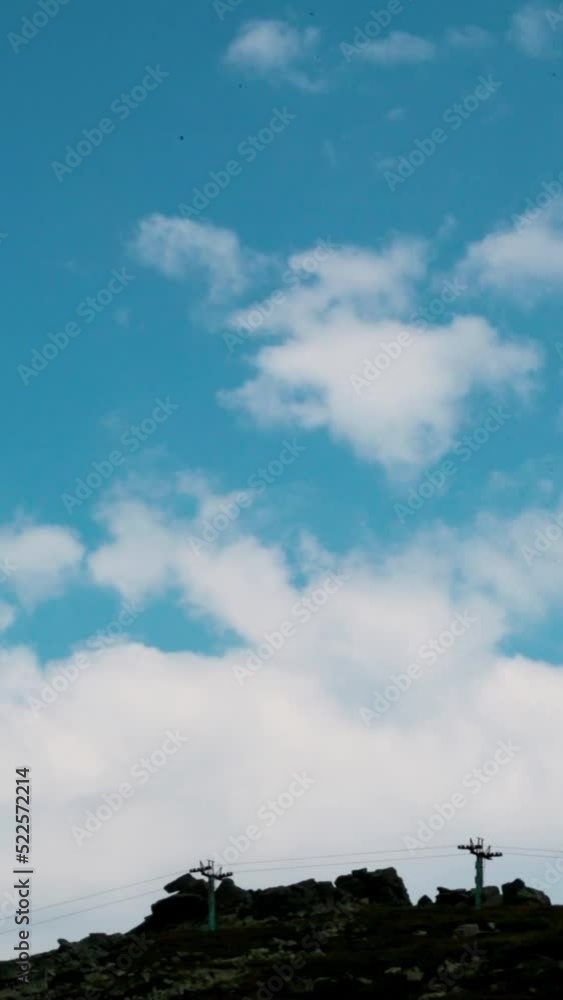 A person paragliding at a mountain peak A person paragliding at a mountain peak