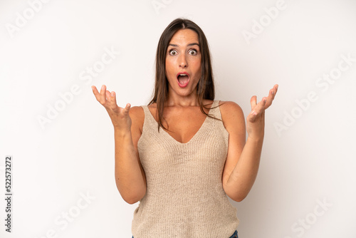 hispanic pretty woman feeling extremely shocked and surprised, anxious and panicking, with a stressed and horrified look