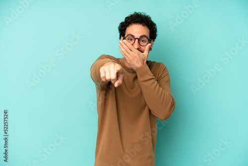 young bearded man laughing at you, pointing to camera and making fun of or mocking you