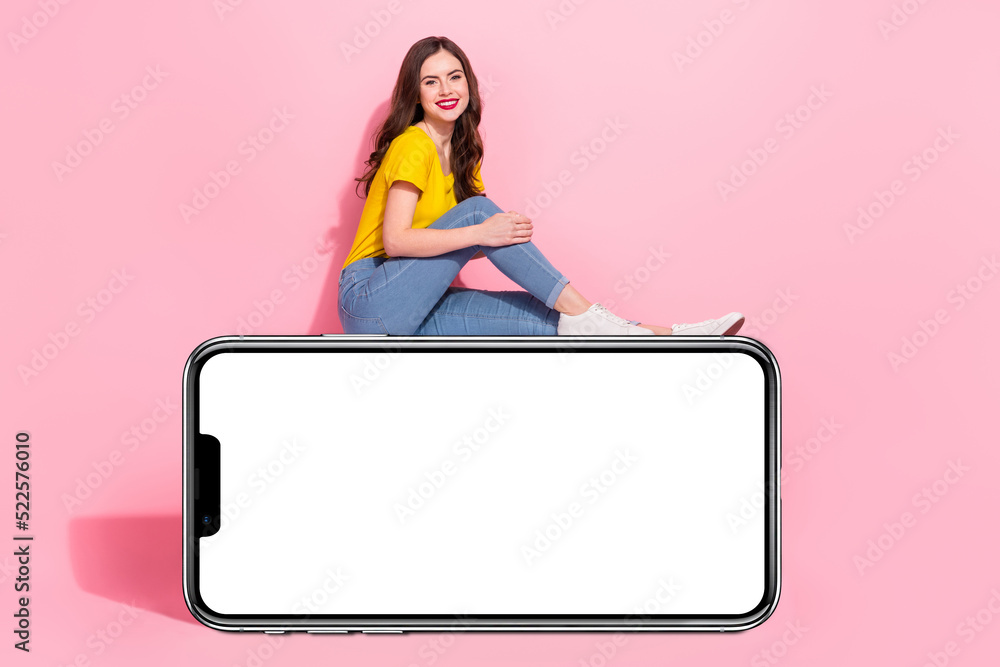 Full body profile portrait of cheerful charming girl sitting empty space blank isolated on pink color background Full body profile portrait of cheerful charming girl sitting empty space blank isolated on pink color background