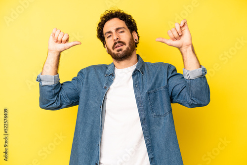 Photography young bearded man feeling proud, arrogant and confident, looking satisfied and s