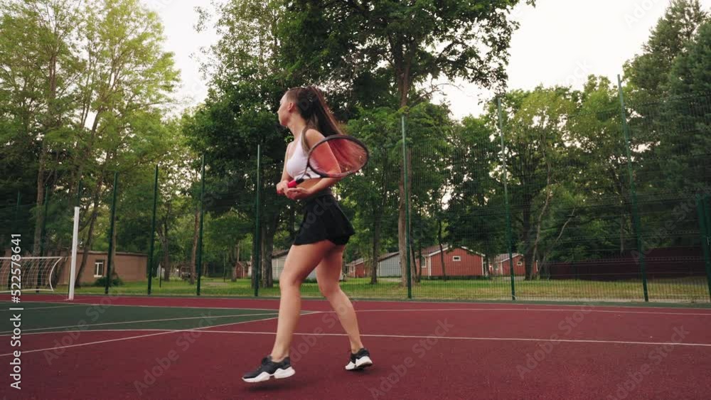 slender female tennis player in court outdoors, athletic woman in short skirt and sporty top slender female tennis player in court outdoors, athletic woman in short skirt and sporty top