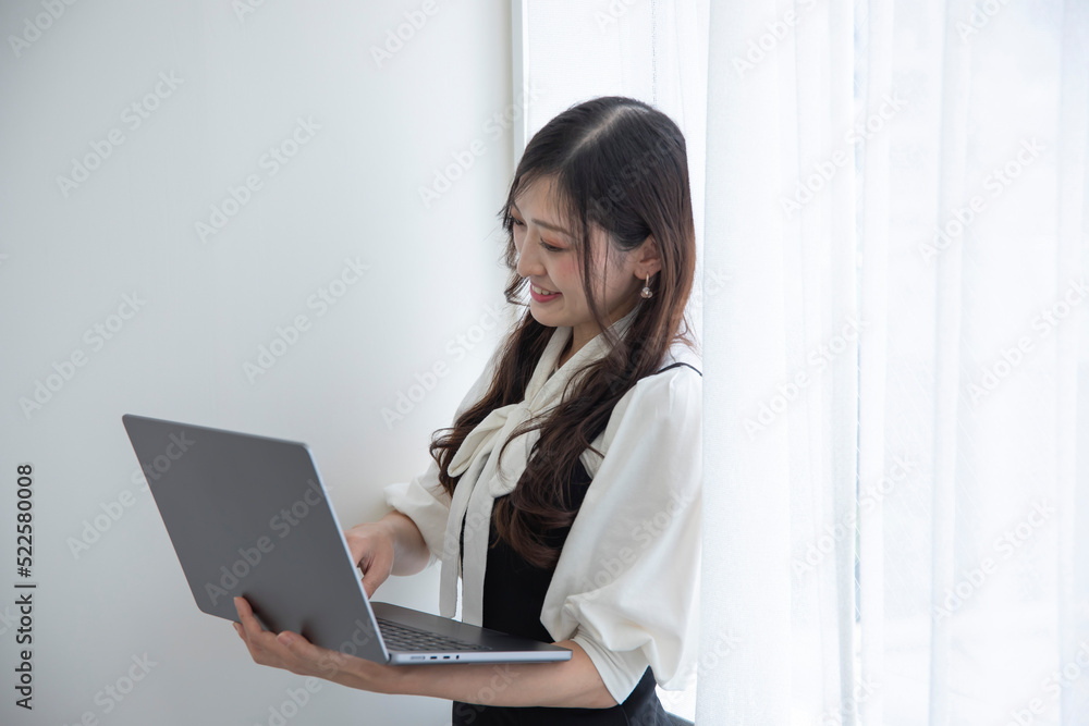 A working Japanese woman by remote work in the home office closeup A working Japanese woman by remote work in the home office closeup