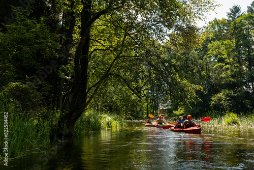 Kayaking trip on the beautiful Czarna Hańcza River, Poland, tourist attraction, two canoes on the river