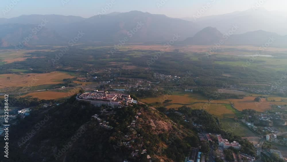 Aerial shot of sacred Hindu temple on hill in Palani, mountain background Aerial shot of sacred Hindu temple on hill in Palani, mountain background