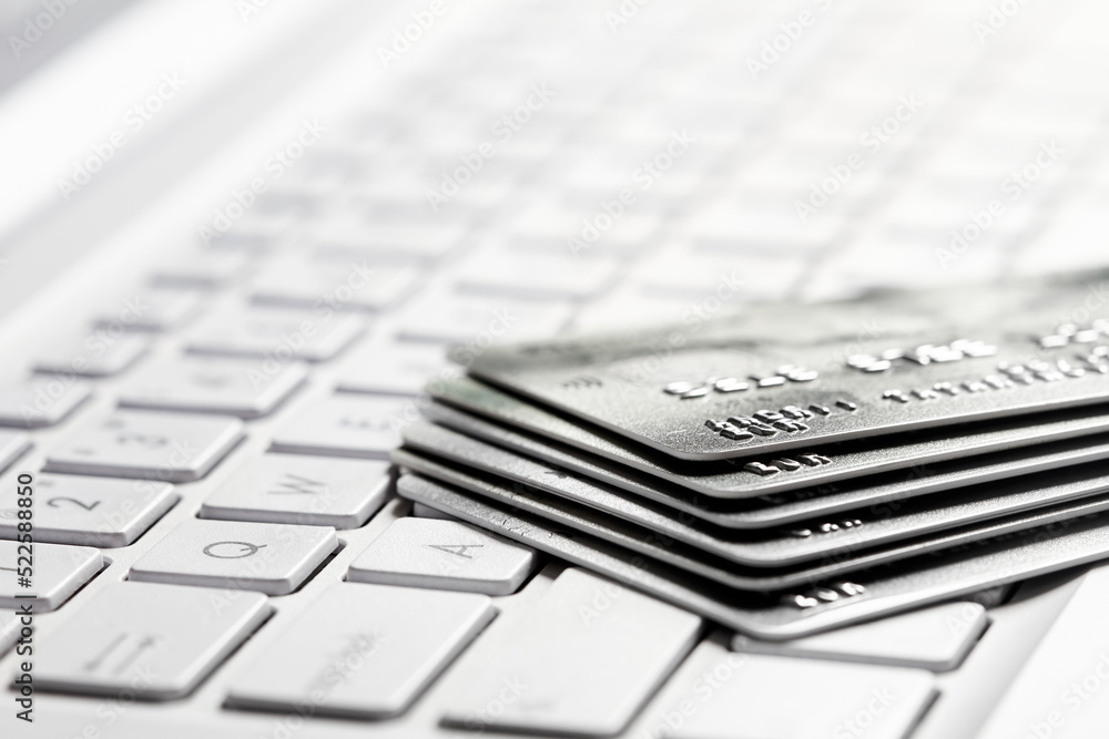 Several bank credit cards on a laptop keyboard Several bank credit cards on a laptop keyboard