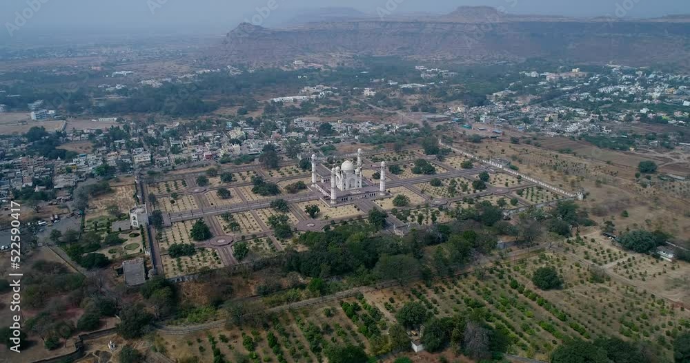 Aerial shot of a marble mausoleum with huge garden, hills in background Aerial shot of a marble mausoleum with huge garden, hills in background