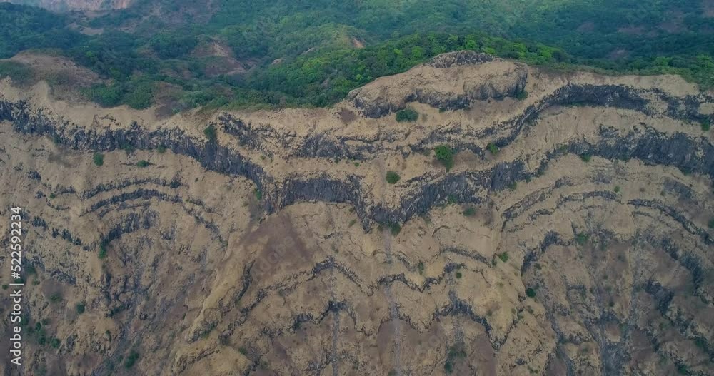 Aerial shot of ridge with steep rocky cliffs and tropical vegetation Aerial shot of ridge with steep rocky cliffs and tropical vegetation