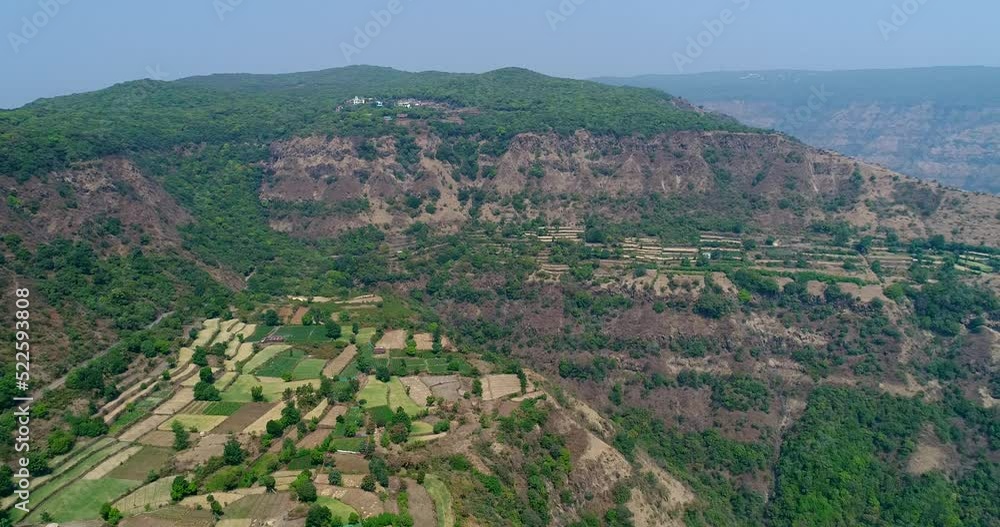 Aerial shot of rice fields on side of hill with steep rocky cliffs around Aerial shot of rice fields on side of hill with steep rocky cliffs around