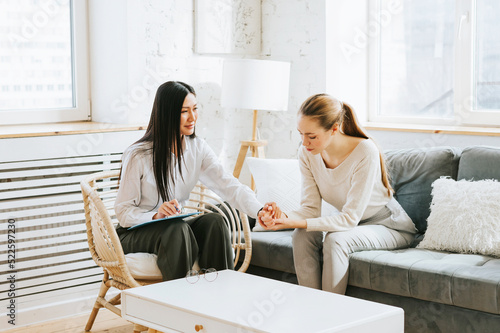 psychological consultation young Asian specialist psychologist or coach conducts a session for a patient of a young woman, problem solving, mental health