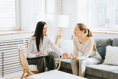 psychological consultation young Asian specialist psychologist or coach conducts a session for a patient of a young woman, problem solving, mental health