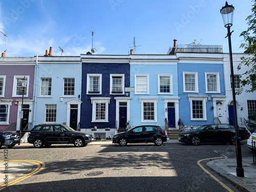 Colorful English houses facades, pastel pale colors in London. Notting hill street view, famous district in London, England. Row of Colourful Old Terraced Houses in the London Neighbourhood of Notting photo