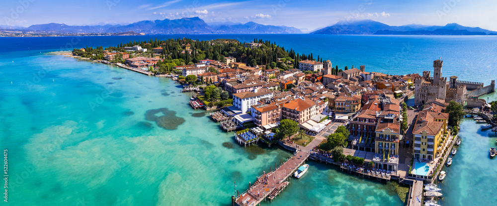 Scenic lake Lago di Garda aerial drone view of Sirmione town and medieval castle Scaligero. Italy, Lombardy