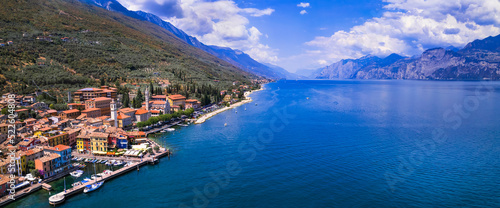 Scenic Lake Lago di Garda, Italy, aerial view of fishing village with colorful houses and boats - Castelletto di Brenzone.