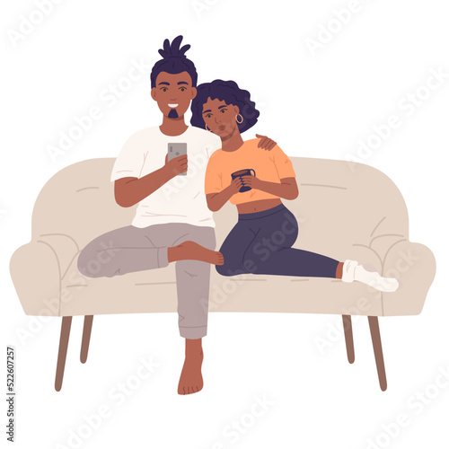 Couple sitting together on sofa and wathcing smartphone. Lovers spending time together.