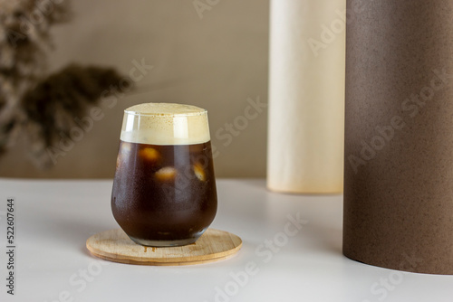 Iced coffee. Coffee cold brew drink cocktail with ice cube on abstract background. Summer refreshing drink concept.