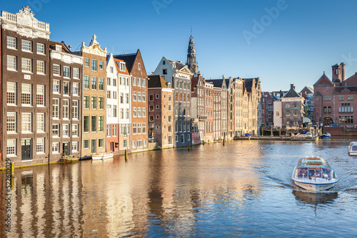 Amsterdam canal with boat and dutch architecture, Netherlands
