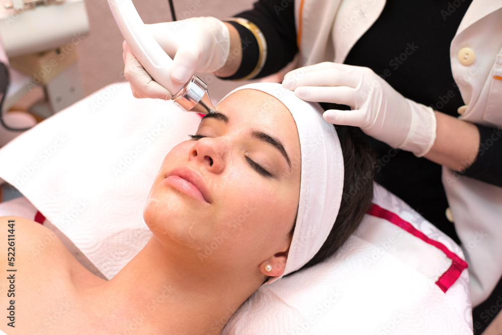 Girl with facial mask lying in beauty health spa center and getting skin beauty treatment	