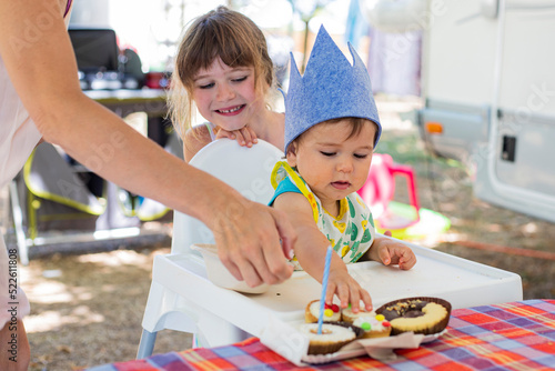 1 year old child first birthday celebration in campground during vacations. photo