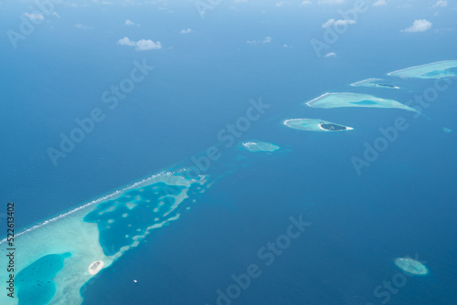 Tropical island with white sand and turquoise water in Maldives, aerial photo, top down view 