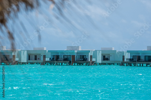Tropical bungallow on blue turquouise sea water in luxury resort island in Maldives 2022 photo