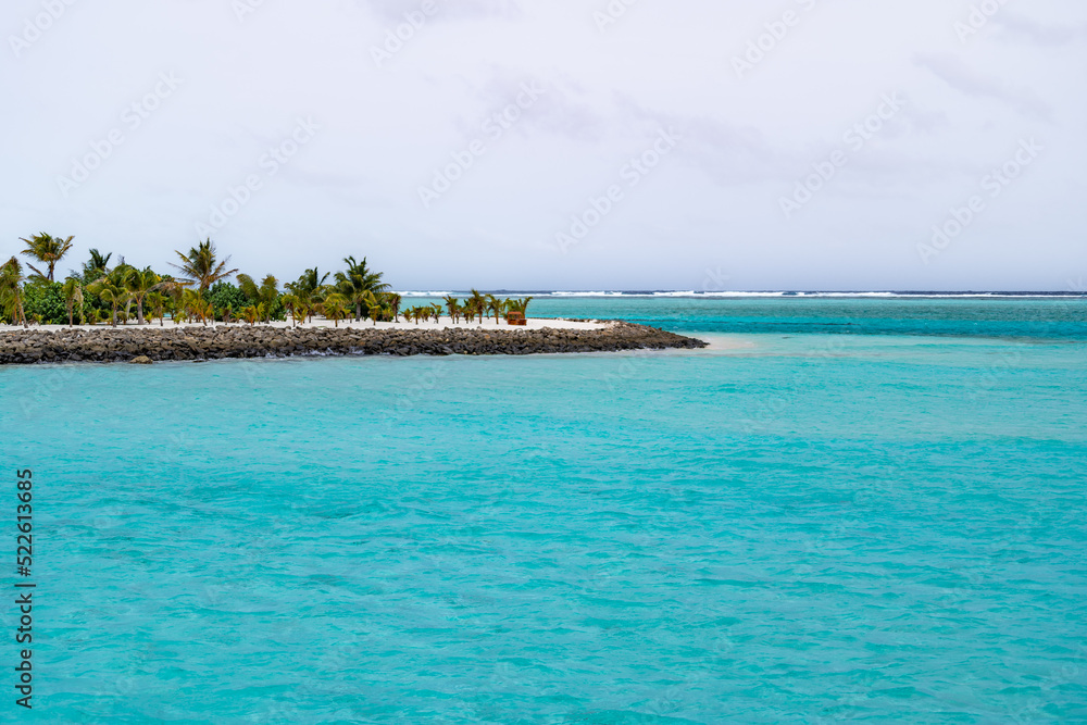 Fototapeta premium Beautiful bay breakwater, with rocks, white sand, palm trees, turquoise water and blue sky in tropical Maldives island