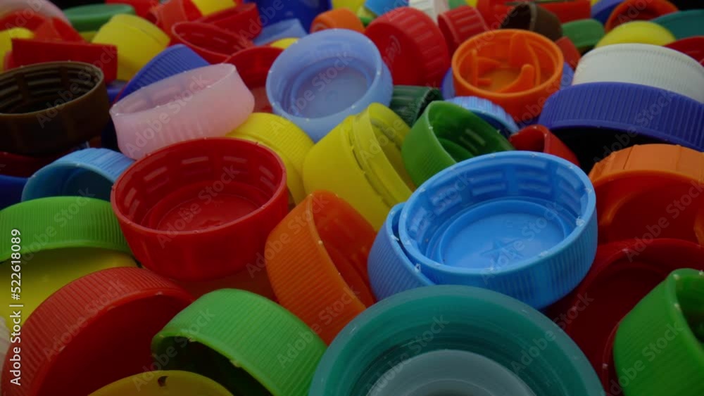 Close-up shot of plastic caps. Multicolored plastic caps background. Slider macro shot Close-up shot of plastic caps. Multicolored plastic caps background. Slider macro shot