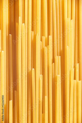 Italian food background, raw spaghetti filling the frame in a creative textured design of uncooked pasta lines.