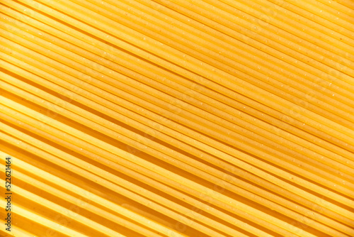 Italian food background  raw spaghetti filling the frame in a textured design of diagonal pasta lines.