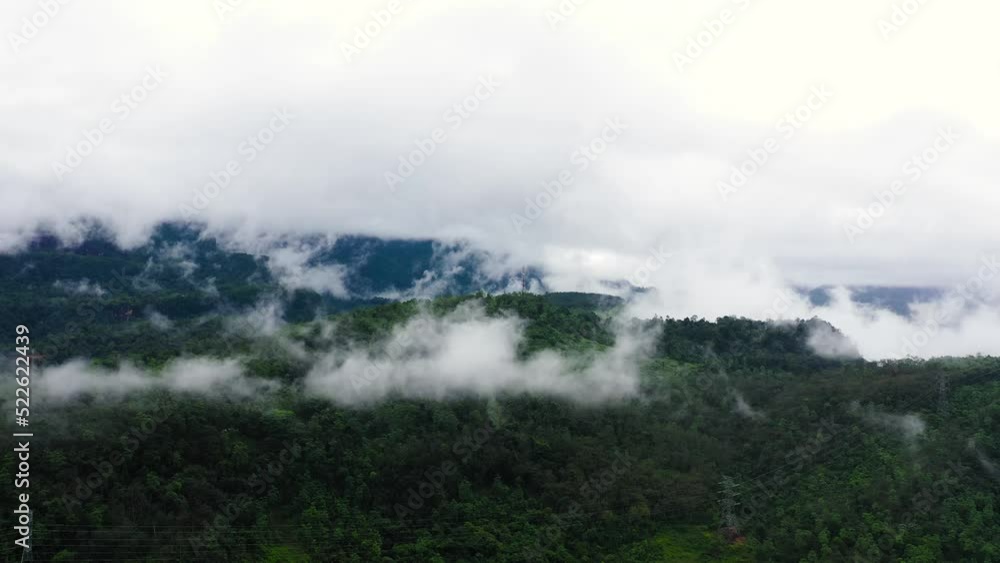 Power line pylon in mountainous area. Power lines among mountains and trees. Sri Lanka. Power line pylon in mountainous area. Power lines among mountains and trees. Sri Lanka.