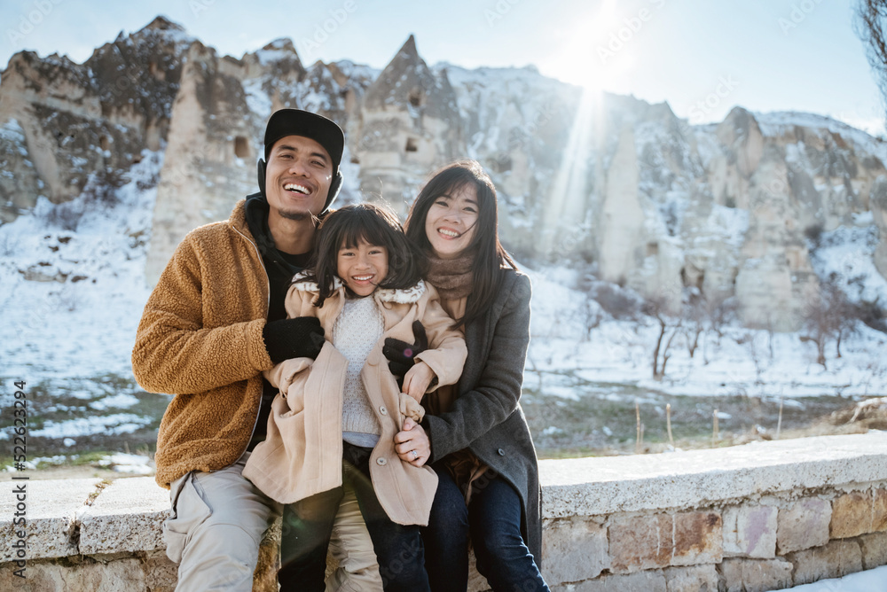 © Odua Images - family kissing each other during travelling in cappadocia enjoying the view of beatiful cave at the background © Odua Images - family kissing each other during travelling in cappadocia enjoying the view of beatiful cave at the background