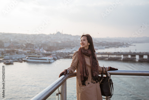 woman tourist enjoying the view of istanbul cityscape from top of the bridge © Odua Images