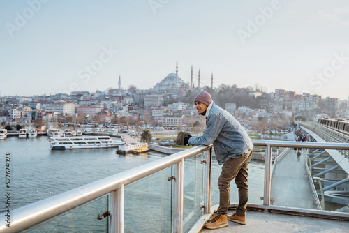 man standing on the bridge while enjoying the view of bosphorus istanbul turkey