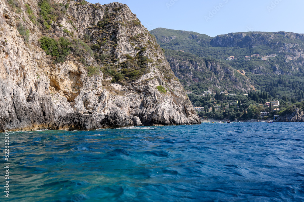 Rocky seasides and ocean views of the coastline of Corfu on a sunny day