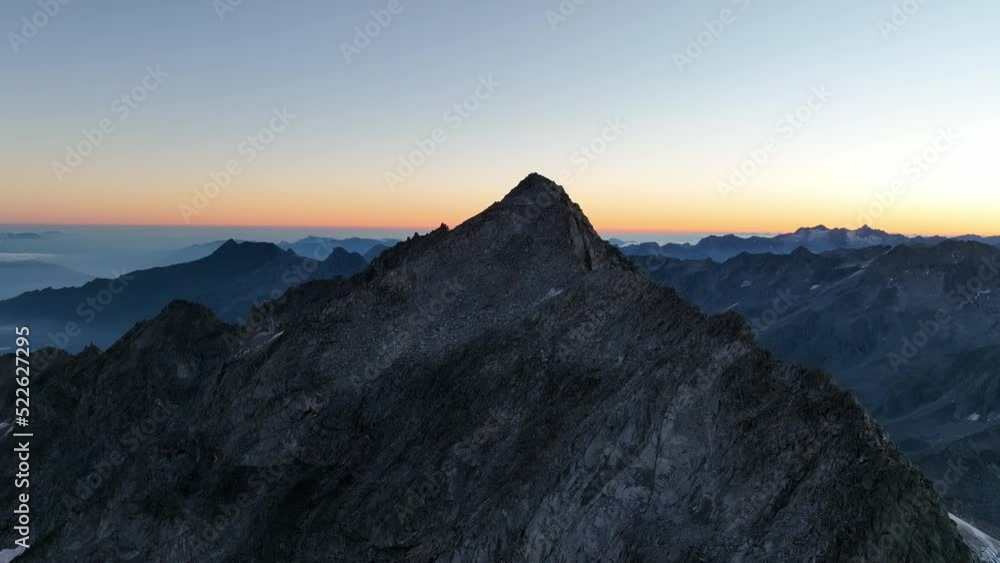 Mountain summit at sunrise in the Alps. Drone footage. Mountain summit at sunrise in the Alps. Drone footage.