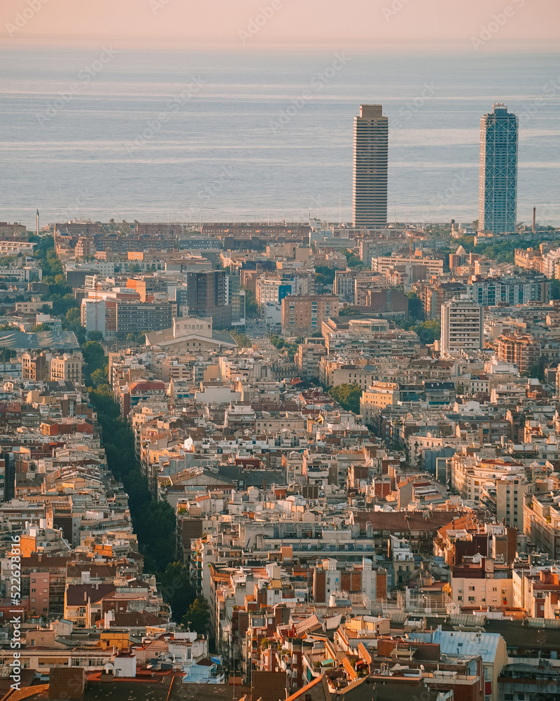 Cityscape view of Barcelona from Bunkers del Carmel at Sunrise with Eixample streets and view of the sea