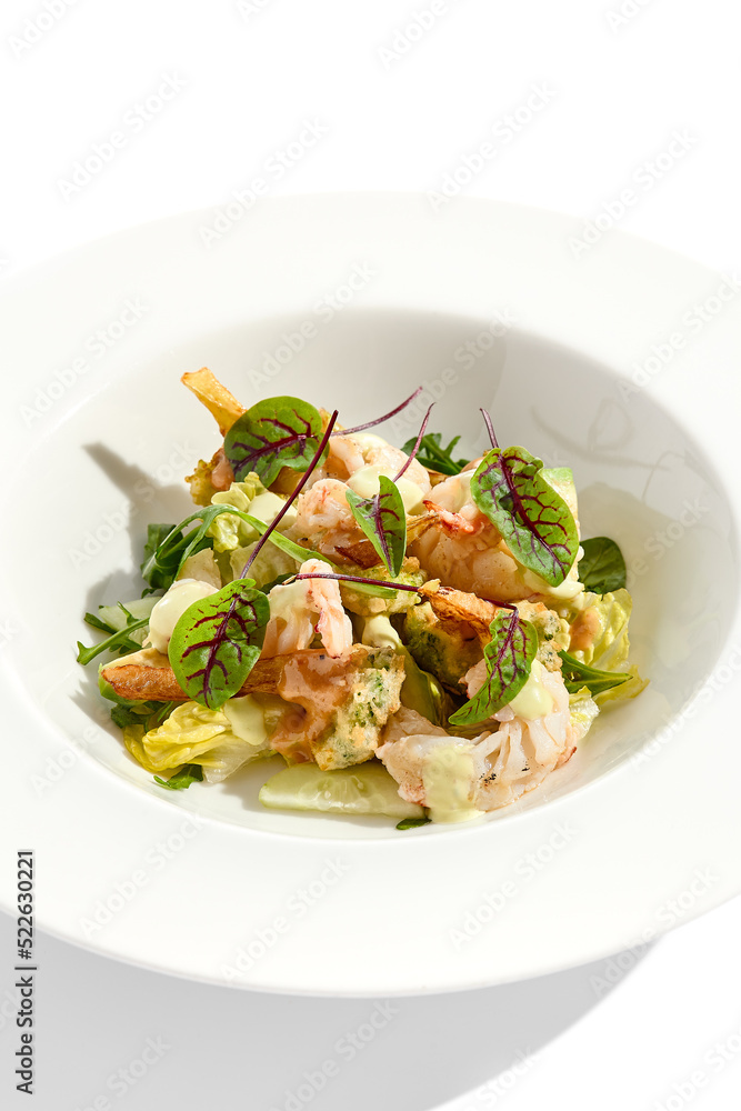 Green salad with broccoli, avocado, shrimps on white plate. Healthy dinner - Salad broccoli and prawns. Clean eating. Green bowl with vegetables and shrimps. Tempura broccoli with avocado, leaf, prawn