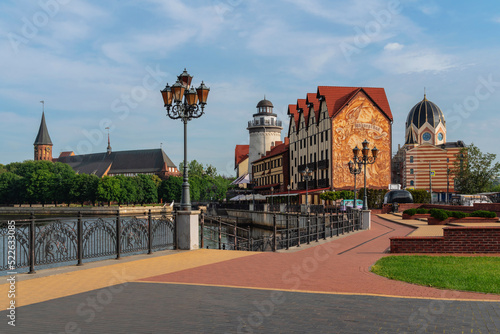 Photos View of the fishing village on the embankment of the Pregolya River on a sunny s