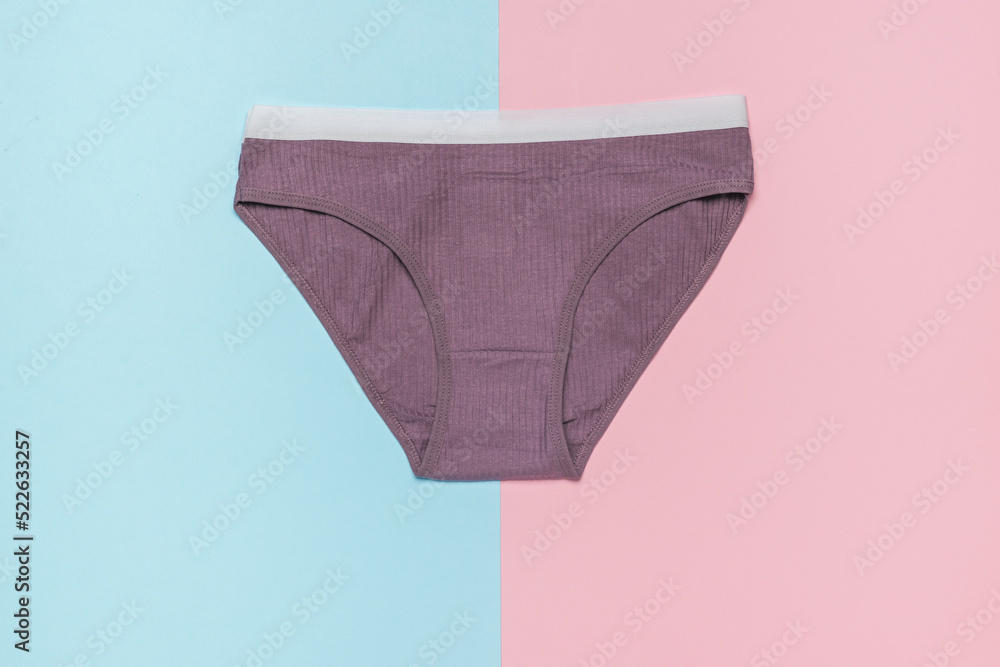Dark women's sports panties on a pink blue background. Minimal concept of women's underwear.
