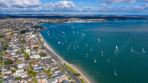 Aerial View from the Beach, Green Trees, City Streets and Waves - Tahuna Torea, Bucklands Beach View in New Zealand - Auckland Area photo