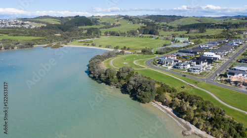 Aerial View of Grahams Beach close to the park, Green Trees and Cliff in New Zealand - Auckland Area © Rodrigo