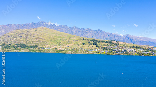 Aerial View from Houses close to the Beach  Lake Wakatipu  Green Trees  Mountains - Queenstown in New Zealand