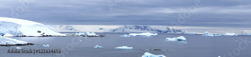 Panorama of icebergs floating in the bay at Portal Point, in Antarctica © Angela