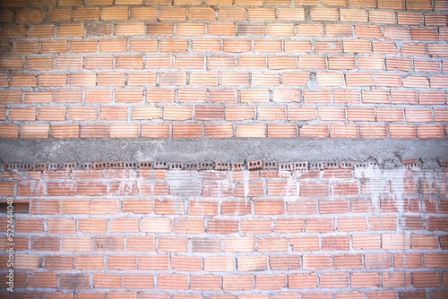 Unfinished cement wall decorative with brick on background