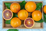 Blood oranges, or Red oranges with leaf on Blue wooden table. 