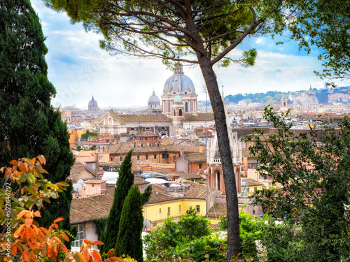 St. Peter Cathedral in Rome framed by trees and plants. Italy